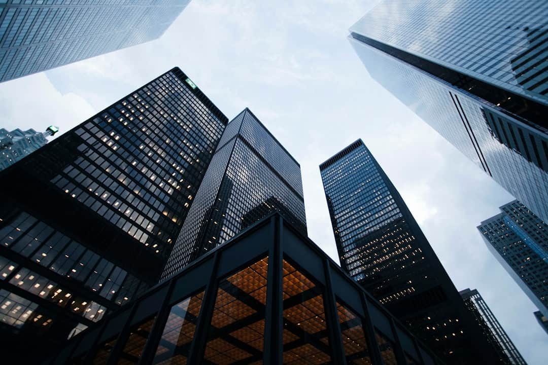 Office skyscrapers in a modern city skyline, representing legal and corporate services by Darío Ewra.