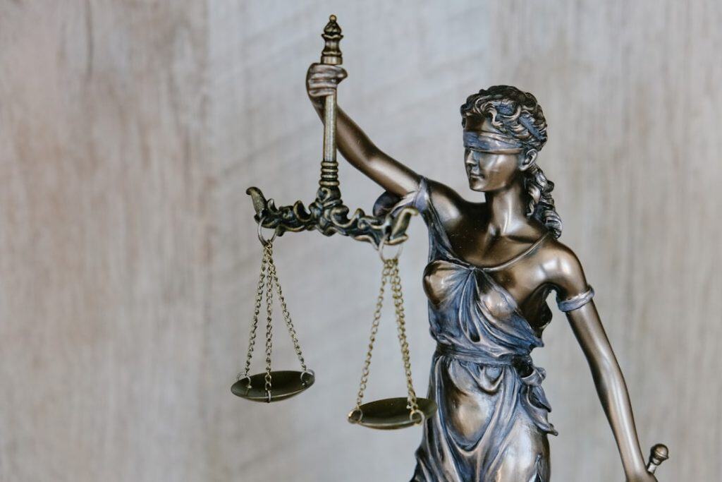 Justice statue holding scales and sword, symbolizing law and fairness.